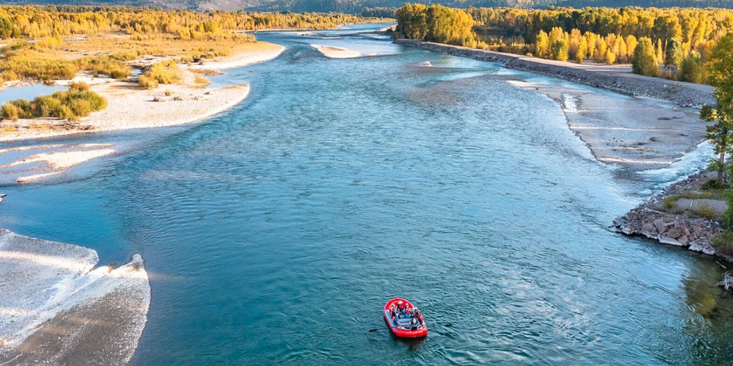 Overhead drone shot of a raft floating down the Snake River