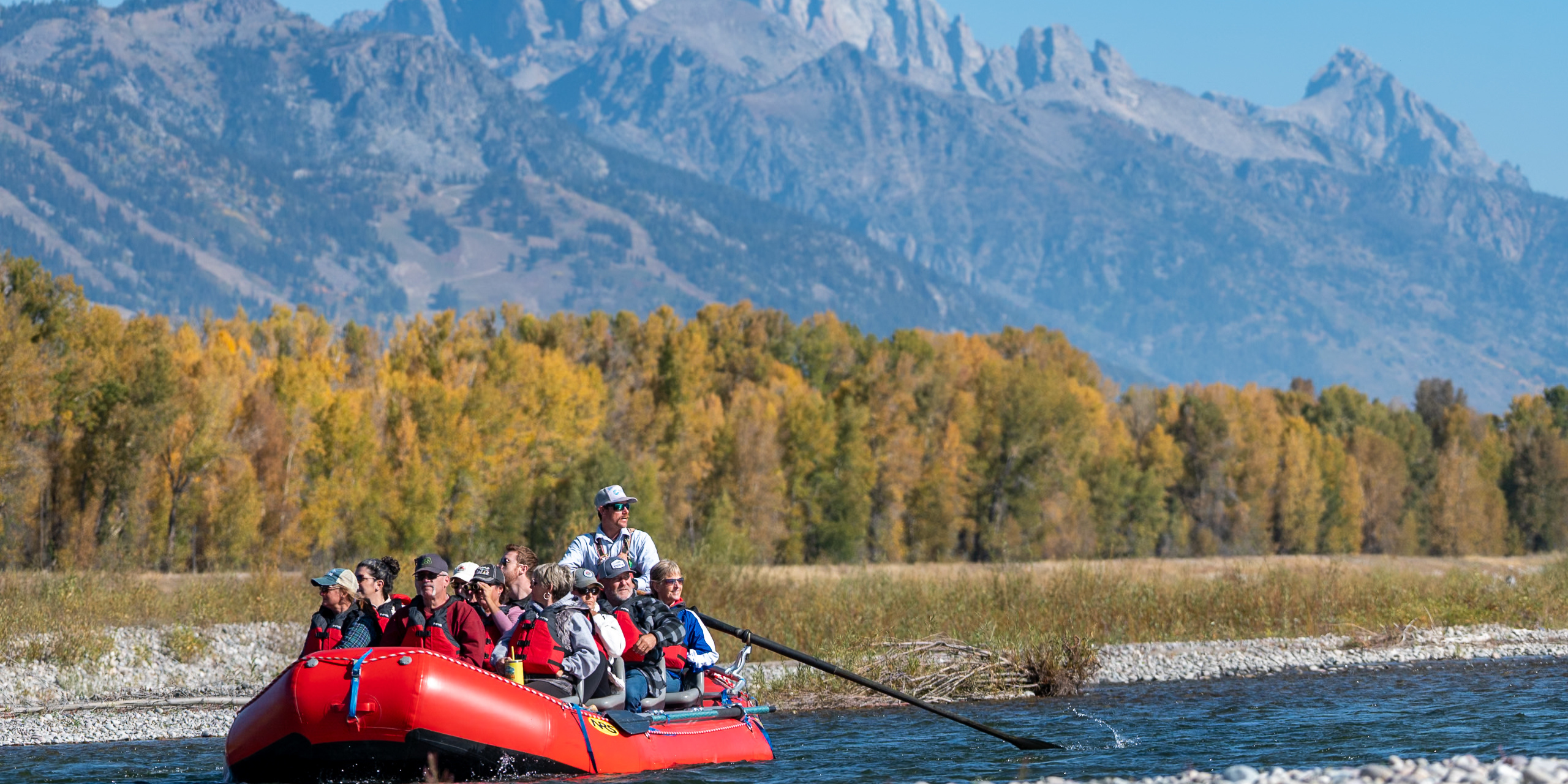 guide leads guests down snake river in boat with seats